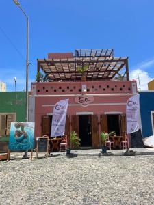 a building with chairs and tables in front of it at Stylish Lagoon Paradise Apartment Boa Vista in Sal Rei +5 photos