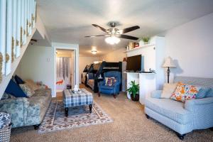 a living room with two couches and a ceiling fan at Creekside Comfort with Resort Amenities in Eden
