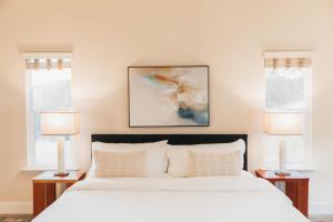 a bedroom with a large bed with two windows at Good Girl's Peak Paradise with bbq and fire pit in Mariposa +37 photos