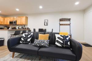 a black couch with pillows on it in a living room at Luxuriously Contemporary Condo in Eden