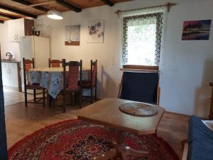 a living room with a table and a kitchen at Domek nad jeziorem, łódka, kajak in Zalewo +37 photos