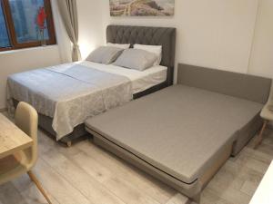 a bedroom with two beds and a table at Pavic SPA Milmari L34 in Kopaonik