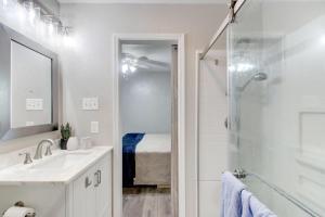 a white bathroom with a sink and a shower at Cozy Home Near Downtown Lawton in Lawton +12 photos