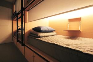 Postel nebo postele na pokoji v ubytování Blueboat Hostel Gyeongju