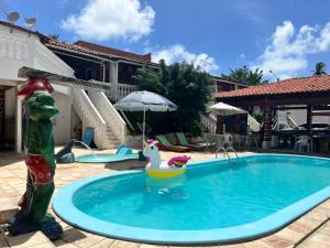 a swimming pool with a toy duck in the middle at Paraíso dos Oliveiras - Ponta de Pedras in Goiana