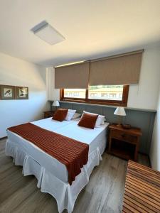 a bedroom with a large bed and a window at Apartamento Barra VIP in Marau +28 photos