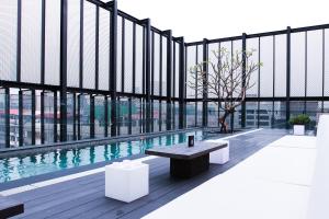a building with a bench and a large window at Hotel Proverbs Taipei in Taipei