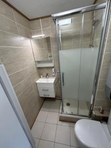 a bathroom with a shower and a sink and a toilet at Chalets du Village - Tily Home - Studio centre village in Villard-de-Lans