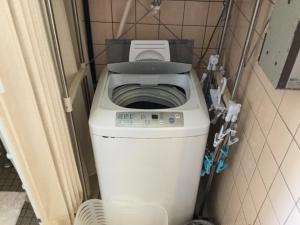 a washer and dryer in a small room at Minshuku Zabaru in Ishigaki Island