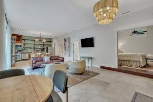 a living room with a table and a couch at The Lincoln Loft, Near Forsyth Park with Free Parking in Savannah