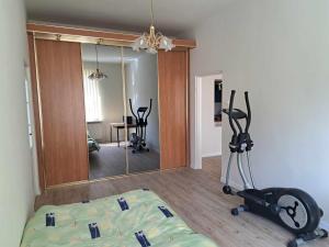 a room with a mirror and a gym with exercise bikes at WlodawaSpot in Włodawa