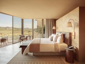 a bedroom with a bed and a large window at Banyan Tree Veya, Valle de Guadalupe in Valle de Guadalupe +144 photos