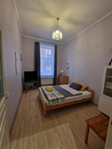 a bedroom with a bed and a chair in it at Riga Central District, Тихий Центр города, всё под боком, удобно in Rīga