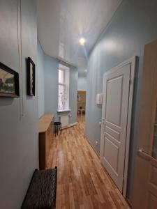 a room with a hallway with a door and wooden floors at Riga Central District, Тихий Центр города, всё под боком, удобно in Rīga +6 photos