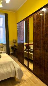 a bedroom with a large wooden wardrobe and a bed at Riga Central District, Тихий Центр города, всё под боком, удобно in Rīga