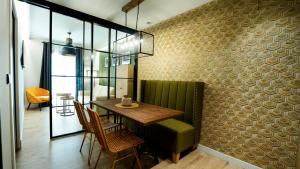a dining room with a table and chairs at Aparthotel Luz de Gades - Suites Spa Gym - Adults Only in Cádiz