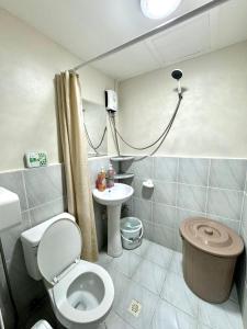 a bathroom with a toilet and a sink at AR's STAYCATION in Lapu Lapu City