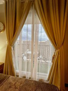 a bedroom with a window with a view of a building at AR's STAYCATION in Lapu Lapu City