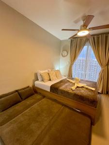 a bedroom with a bed and a couch and a window at AR's STAYCATION in Lapu Lapu City