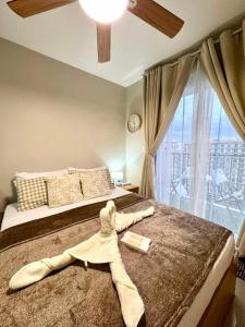 a towel laying on a bed in a bedroom at AR's STAYCATION in Lapu Lapu City