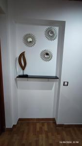 two mirrors on a white wall with a shelf at Estudio Santa Catarina in Málaga