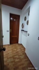 a hallway with a door and a wooden floor at Estudio Santa Catarina in Málaga