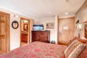 a bedroom with a bed and a flat screen tv at 1 Bedroom Ski In, Ski Out Mountain Vacation Rental Located Next To Historic Main Street In Downtown Breckenridge in Breckenridge +15 photos