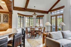 a kitchen and dining room with a couch and a table at 5 Bedroom Luxury Townhome In Lionshead Village in Vail