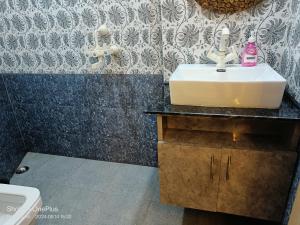 un baño con lavabo e inodoro en Good Vibes Hotel, en Agra
