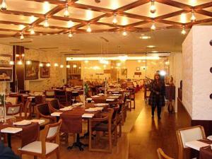 a person walking through a restaurant with tables and chairs at Hotel Restaurante Salvadora in Villena
