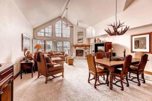 a large living room with a table and chairs at Ski, In Ski Out 3 Bedroom Vacation Condo With Resort Amenities That Include Exercise Center, Indoor Pool, And Hot Tubs in Beaver Creek