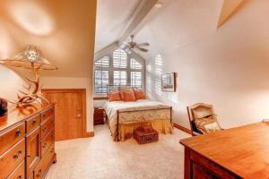 a bedroom with a bed and a window at Ski, In Ski Out 3 Bedroom Vacation Condo With Resort Amenities That Include Exercise Center, Indoor Pool, And Hot Tubs in Beaver Creek +10 photos
