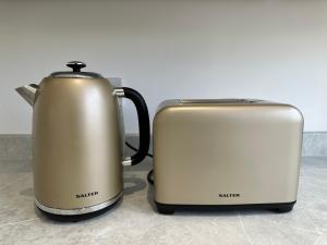 two toasters sitting next to each other on a counter at Elite 3 bedroom family house with free parking in Newton Mearns