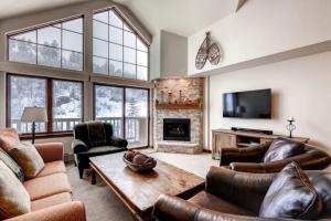 a living room with leather furniture and a fireplace at Beaver Creek St James 4 Bedroom in Beaver Creek