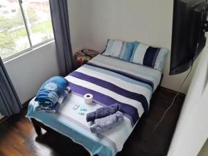 Un pat sau paturi într-o cameră la San Miguel Rooms Lima Airport B&B
