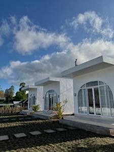 a white house with a cross on top of it at Montana villas by volcano garden in Kubupenlokan