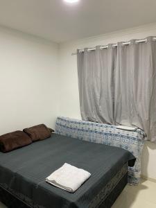 a bed sitting in a room with a window at Casa 186 in Juazeiro do Norte