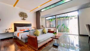 a bedroom with a bed and a couch and a window at The Calm Oasis in Siem Reap