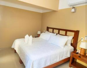 Ένα ή περισσότερα κρεβάτια σε δωμάτιο στο The garden hotel palenque