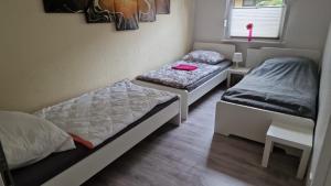 a room with two beds and a window at Ostwind in Bochum