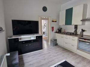 a kitchen with a flat screen tv on a counter at Ostwind in Bochum +1 photo
