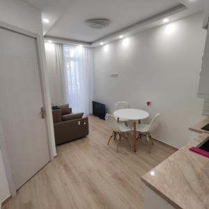 a living room with a table and a couch at Moriya in Batumi