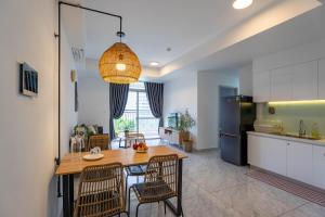 a kitchen and dining room with a table and chairs at Roomio Paris Hoang Kim-Shared Apartment in Ho Chi Minh City