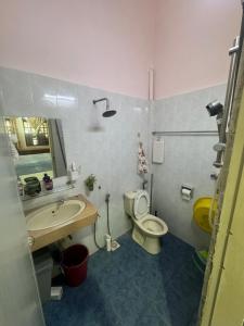a bathroom with a toilet and a sink at Jun home in Kuantan