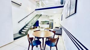 a kitchen and dining room with a table and chairs at EkoCheras Suites, Kuala Lumpur 1-4 Pax in Kuala Lumpur