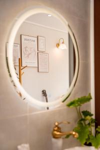 a mirror over a sink in a bathroom at Mật Pet Farm - Mộc Châu in Mộc Châu
