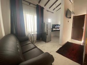 a living room with a couch and a refrigerator at Serendib Villa in Negombo