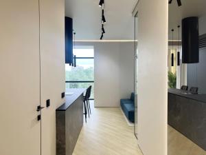 a kitchen and dining room with white walls at PREMIUM апартаменты в парке in Pavlodar +32 photos