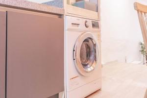 a washing machine in a kitchen next to a counter at Namsan Tower View - duplex, 3rooms 2toilets in Seoul