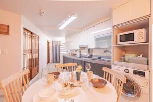 a kitchen with a white table and chairs in a room at Namsan Tower View - duplex, 3rooms 2toilets in Seoul